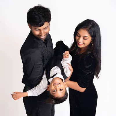 The best kind of family fun is being silly together! This playful moment with mom and dad holding their son upside down captures the joyful, loving spirit of this family.