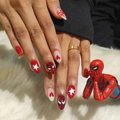 Your friendly neighborhood nail art. This custom set features hand-painted Spiderman masks, webs, and logos for a true Marvel fan. It’s proof that nail art is for everyone.