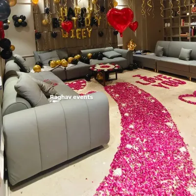 A grand romantic gesture for a wife's birthday. This living room decoration includes a rose petal pathway, 'I LOVE YOU' written on the floor, and a 'Happy Birthday Wifey' balloon setup.
