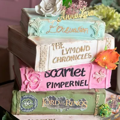 Turning pages and turning heads. This vintage books-themed cake is a story in every bite, featuring edible versions of favorite novels like 'Lord of the Rings' and 'Persuasion'.