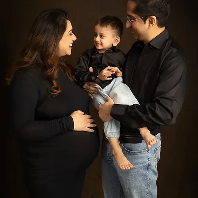 The pure joy of a family growing. This candid moment captures the laughter and love as they share their excitement with their firstborn. Family maternity sessions are a wonderful way to include everyone in the celebration.