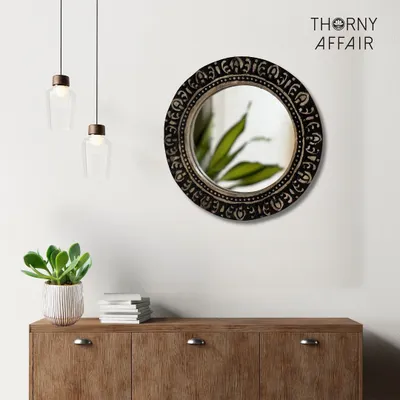 The classic round mirror, reimagined with traditional Indian carving. The dark finish on this mango wood frame adds a touch of rustic sophistication, making it a versatile piece that complements both modern and eclectic decor styles.