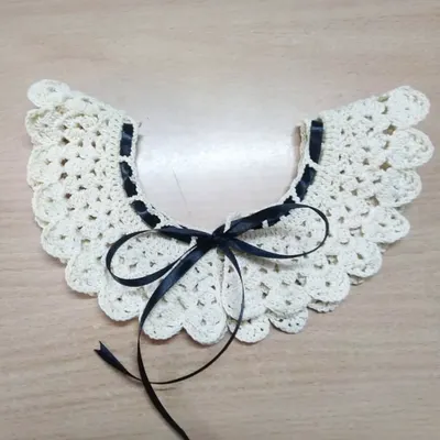 This is one of our detachable crochet collars, designed to look like angel wings. You can add it to any simple blouse or dress for a touch of vintage charm.