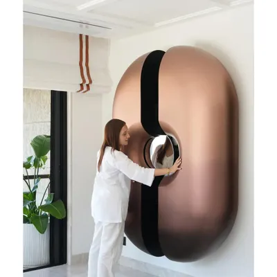 Our viral statement bar unit is more than just furniture; it's a piece of kinetic sculpture. Located in the lounge of a Mumbai duplex, the pod-like structure slides open to reveal a fully stocked bar, complete with a mirrored counter. It’s a testament to innovative design and functional art.