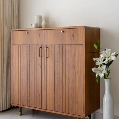 This multipurpose unit from our 'Marshall' collection features our signature curved edges, brass-clad legs, and fluted shutters. It can serve as a crockery cabinet, a bar, or a stylish storage piece in any room.