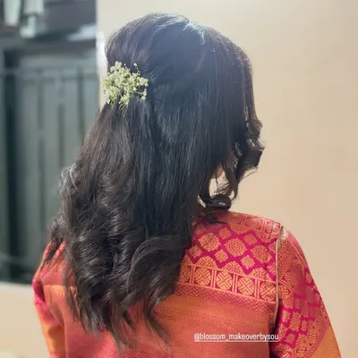Soft, loose curls are a timeless choice for any special occasion. For this look, we did a simple half-up twist and added a small sprig of baby's breath for a touch of elegance.