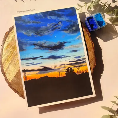 A custom A5 skyscape painting I completed for an order. The dramatic blue and orange sunset over the city silhouette was so much fun to create using gouache.