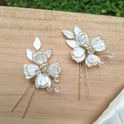 Our delicate, handcrafted floral hair pins are perfect for a bridal look or any special occasion. Each petal is lovingly shaped and adorned with shimmering crystals for a subtle, romantic sparkle.