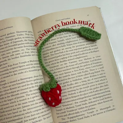 Here is my crochet strawberry bookmark in action. The long green stem and leaf rest outside the book so you never lose your spot.