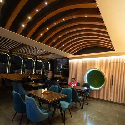 I paid a lot of attention to the details, like the warm, arched wooden ceiling and the unique circular moss art on the wall. Every corner is designed to be a cozy spot for you to settle in and relax.