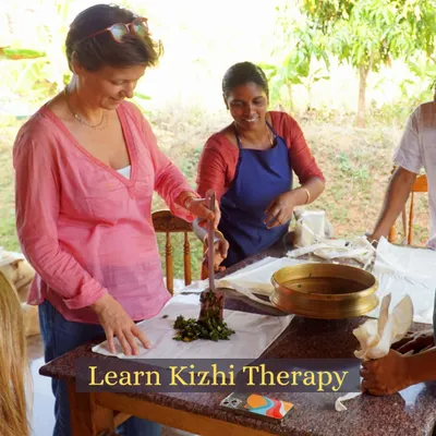 A student learns the art of preparing a Kizhi poultice. Our hands-on workshops guide you through creating these therapeutic herbal bundles, a key skill for anyone studying Ayurvedic massage and pain relief therapies.
