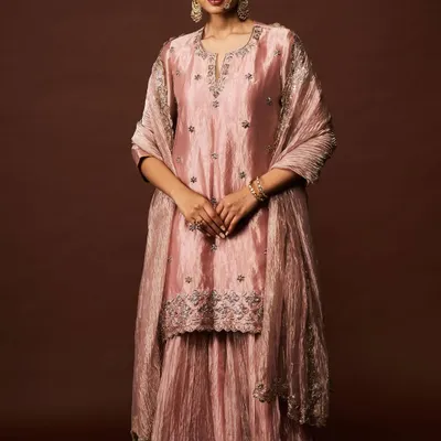 A vision in dusty rose. This shimmering sharara set with delicate silver embroidery exudes a quiet and sophisticated charm, perfect for any celebration.