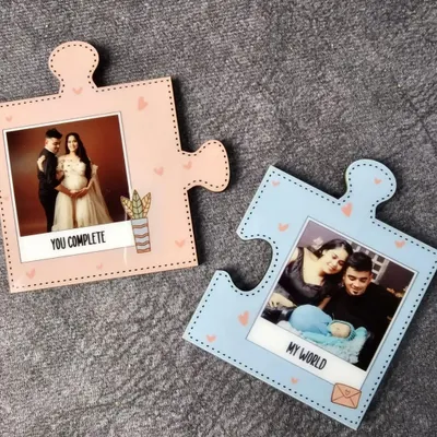 These interlocking puzzle piece magnets are a sweet gift for couples. One piece says 'You Complete Me' and the other says 'My World', each holding a special photo.