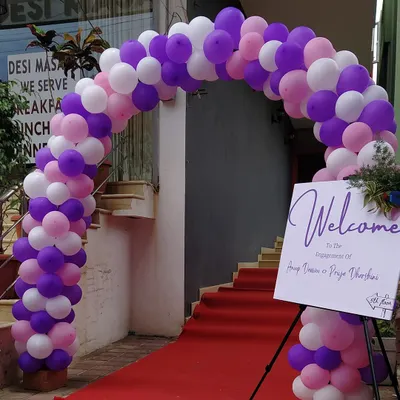 This engagement party entrance was designed to feel grand and celebratory. The setup included a lush balloon arch, a red carpet walkway, and a custom welcome sign featuring the couple's names.