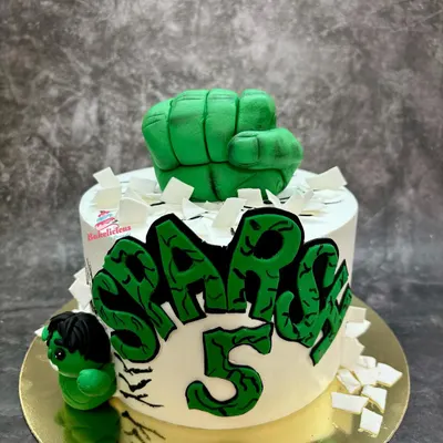Hulk smash! This action-packed cake features a powerful fondant fist bursting through the top and a mini Hulk figure. The graffiti-style name makes it a cool centerpiece for a 5th birthday.
