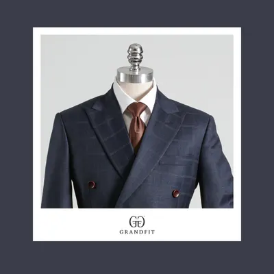 A modern take on the double-breasted style, this navy suit features a subtle check pattern. The peak lapels and structured shoulders create a distinctly masculine and sophisticated look.