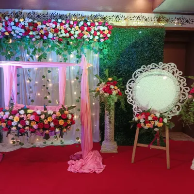 For this naming ceremony, we created a beautiful setup featuring a decorated floral swing, or jhoola. The backdrop combines a green wall with light drapes and fairy lights, making it a perfect spot for photos.