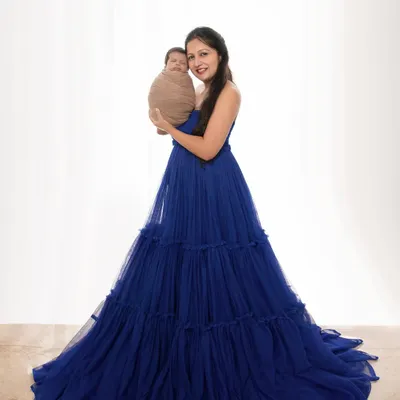 A mother's love, captured in a single, elegant frame. Here, a new mom holds her swaddled baby, creating a portrait of pure grace and connection that she will treasure for a lifetime.