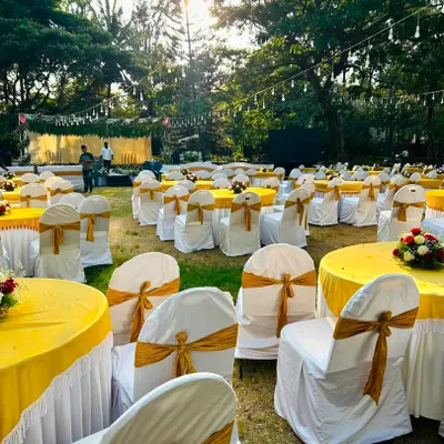 I can manage decorations for large scale outdoor corporate events. Here is a complete seating arrangement with custom chair covers, tablecloths, and floral centerpieces, ready for guests.