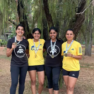 Four of our strong women runners proudly displaying their medals after the Wings for Life World Run. The smiles say it all. This is the result of consistent training and community support.