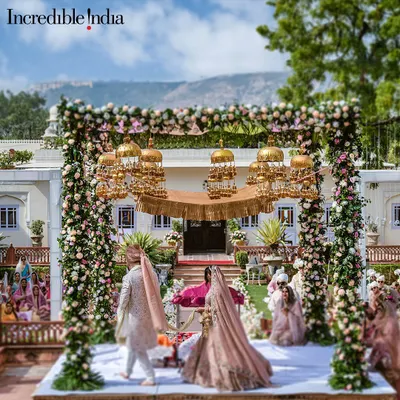 A shot of a grand floral mandap with golden kaleeras, featured by Incredible India to promote royal weddings in Jaipur.