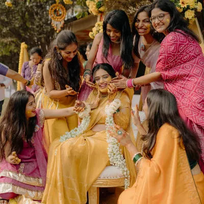 The bride surrounded by her best friends during the Haldi ceremony. This is a moment of pure joy and friendship, a memory to be cherished forever.