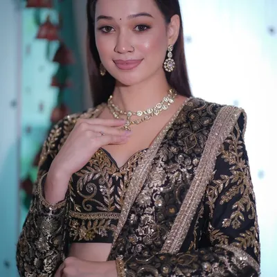 A perfect look for a Sangeet or reception. This black and gold embroidered lehenga is paired with soft, glowing skin, shimmery eyes, and a glossy nude lip for a classic, bold, and graceful statement.
