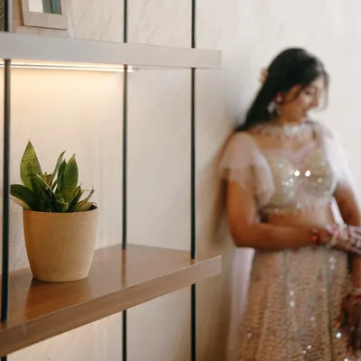 A candid portrait of the bride during her Sangeet ceremony. The soft focus and warm lighting create a dreamy and happy atmosphere.