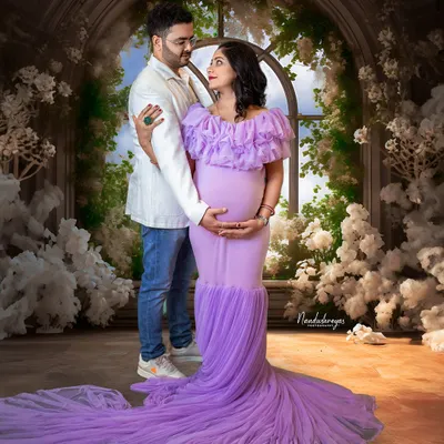 A classic couple's portrait in our fairytale studio. The flowing lavender gown and the backdrop of white flowers create a scene straight out of a dream.