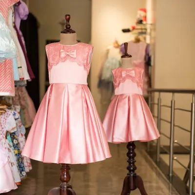Double the elegance in these matching pink satin party dresses. Featuring a beautiful lace bodice and a full, pleated skirt, these are perfect for creating unforgettable sister moments at any special occasion.