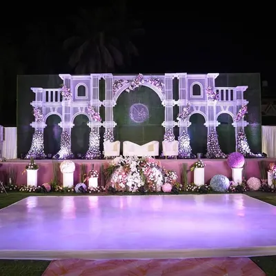 This grand stage, with its palatial white arches and delicate floral accents, was designed to be the perfect royal backdrop for the wedding couple. The elevated platform and soft lighting ensure all eyes are on them.