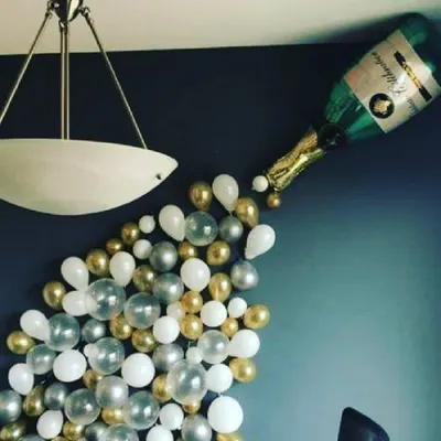 I can create fun and creative balloon art, like this champagne bottle design. It's a unique centerpiece that adds a playful and celebratory touch to any birthday or anniversary party.