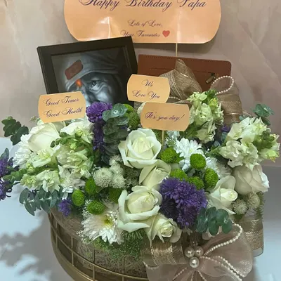 The perfect last-minute birthday delivery for a beloved father. This floral hamper includes a spiritual touch with a Sai Baba frame, a personalized note, and fresh white and purple flowers.