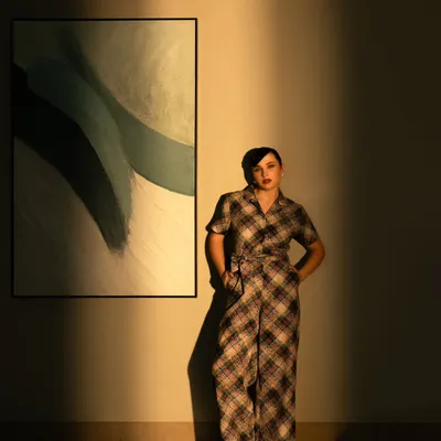 A high-fashion shot using dramatic shadows and warm light. This style is perfect for a brand campaign that wants to create a moody and artistic look.