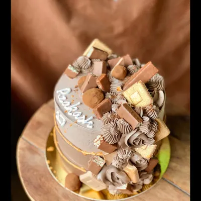 My Chocolate Overload cake is a dream come true for any chocolate lover. It's topped with a mountain of various chocolates like KitKat, Dairy Milk, and chocolate truffles.