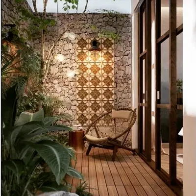 This backyard patio has a rustic, Mediterranean feel. I used a natural stone wall, a patterned tile accent, and a wooden deck floor to create a warm and inviting seating area, perfect for a quiet morning coffee.