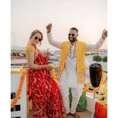 A cool, candid shot of the couple on a yacht in Dubai during their pre-wedding party. The sunset and their relaxed poses make for a perfect party picture.