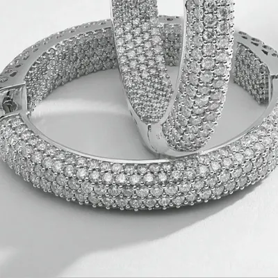 This macro photograph captures the intricate detail of pavé-set diamond hoop earrings. Every single diamond is in sharp focus, demonstrating the precision required for high-end e-commerce imagery where texture and quality are paramount.