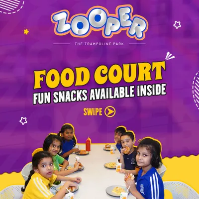 My food court offers fun snacks for everyone. After a session of jumping, a group of school kids sits down to enjoy a tasty meal together.