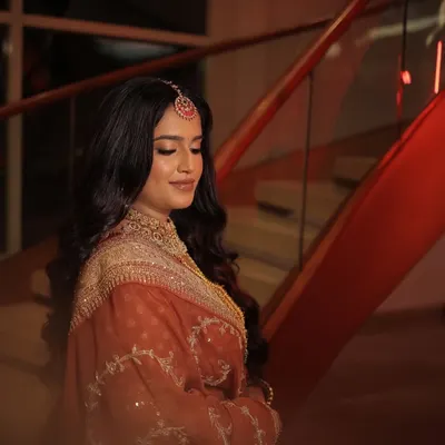 A moody and romantic shot of our bride's reception look. The soft glam makeup and beautiful open hairstyle with a maang tikka create a look of understated elegance.