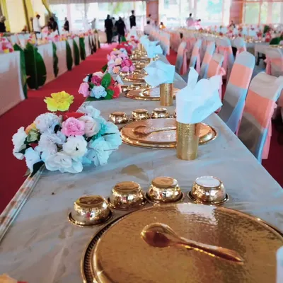 A close-up of our traditional golden thali setting. Each element, from the hammered plate to the small bowls, is chosen to create an authentic and luxurious dining experience.