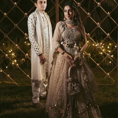 A beautiful portrait of the couple during their Garba night, showcasing their stunning, coordinated outfits against a backdrop of warm, festive lights.