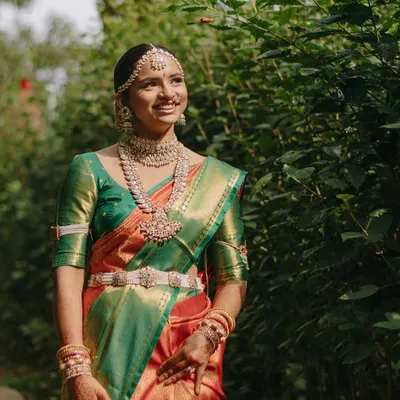 A portrait of my beautiful bride Meghna at her Mahuratham in Coorg. Her look features classic South Indian bridal makeup with defined eyes, a traditional hairstyle, and makeup that complements her rich silk saree.