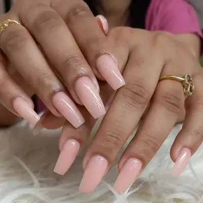 A flawless set of long, coffin-shaped extensions in a classic, glossy nude pink. This simple yet stunning look is versatile and perfect for elongating the fingers.