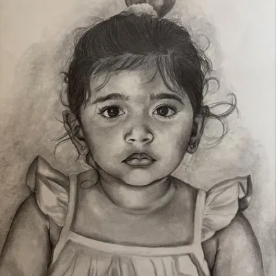 This detailed pencil sketch of a little girl captures her soulful eyes and gentle expression. I love working with graphite to bring out the soft features and innocence of children.