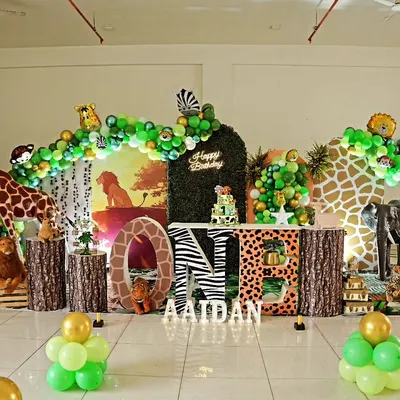 Aaidan's first birthday was a walk on the wild side with this elaborate jungle theme. We used a life-sized giraffe prop, animal print "ONE" letters, a greenery backdrop, and a lush balloon arch to create a full safari experience.