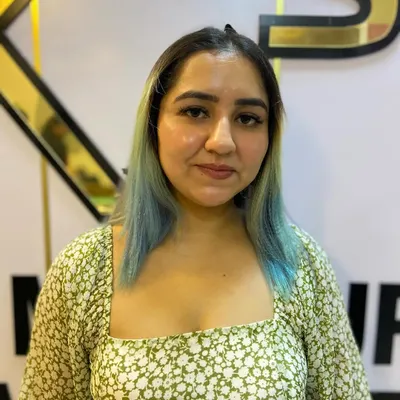 A glimpse of a creative hair coloring service, featuring a beautiful blend of natural dark hair with a vibrant light blue ombre effect. This is a great way to express personality through your hair.