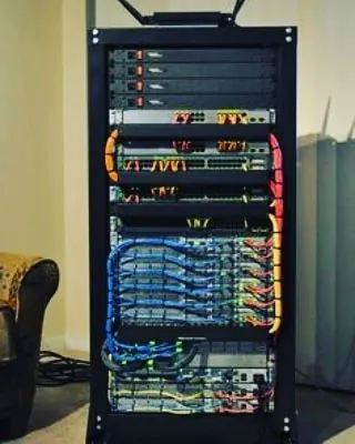 A perfect example of our structured cabling service in a free-standing server rack. This level of organization prevents future issues and makes maintenance simple.