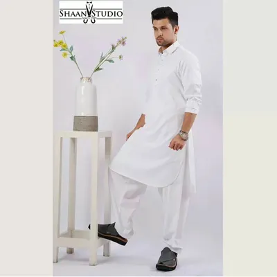 A professionally shot image of our classic white Pathani suit. This custom-tailored set is crafted for a clean, sharp look, making it an essential and timeless piece for any man's ethnic wardrobe.