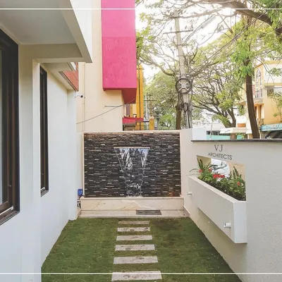 This small side yard in Hubli was transformed into a private oasis with a custom water feature, a neat lawn, and a stone pathway. It's a perfect example of our ability to create functional and beautiful landscape designs in tight urban spaces.